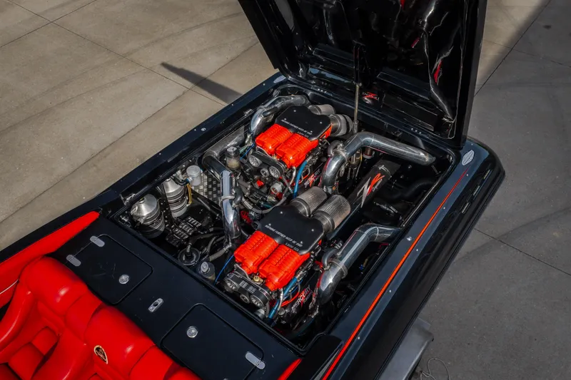 Slide: The Image of Engine view of 2009 Donzi 38 ZRC boat with vibrant red accents. - 24