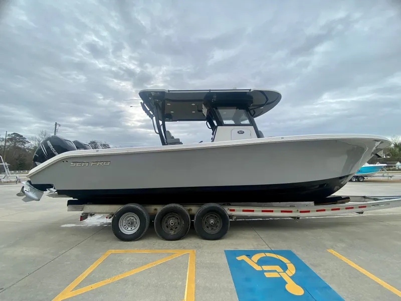 Slide: The Image of 2022 Sea Pro 320 DXL boat on a trailer in a parking lot. - 1