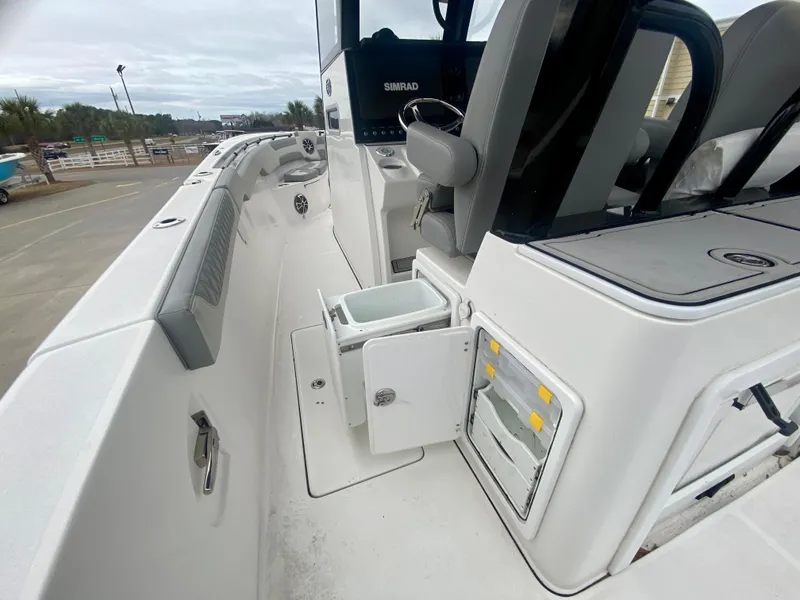 Slide: The Image of 2022 Sea Pro 320 DXL boat interior with storage compartments and seating. - 17