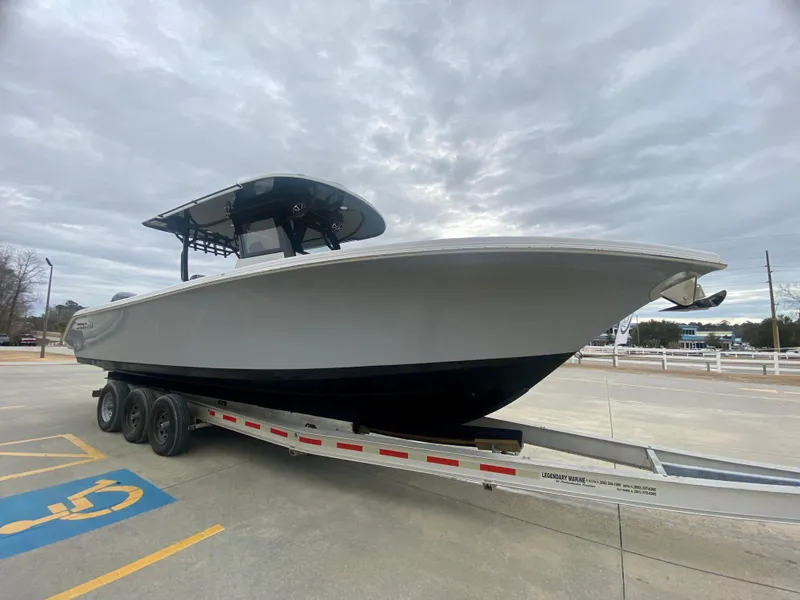 Slide: The Image of 2022 Sea Pro 320 DXL boat on a trailer in a parking lot. - 2