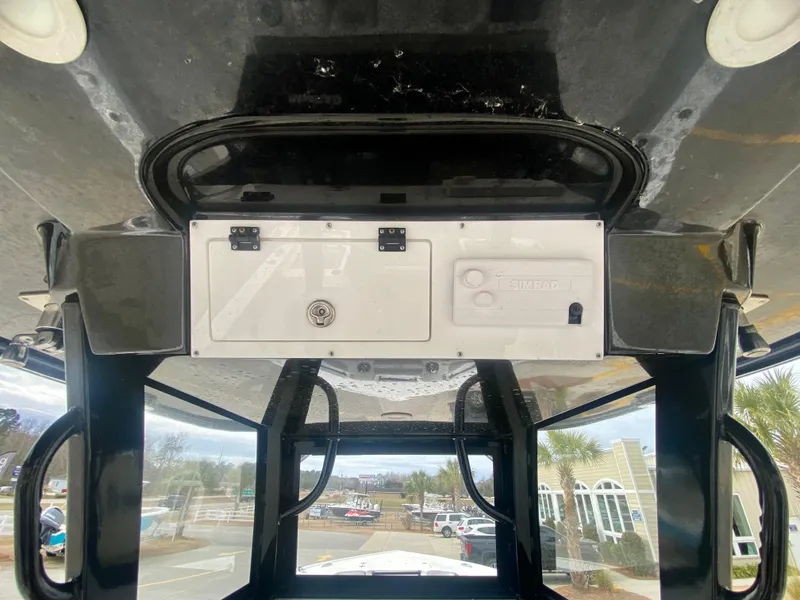 Slide: The Image of Sea Pro 320 DXL 2022 boat console with overhead storage and control panel. - 24