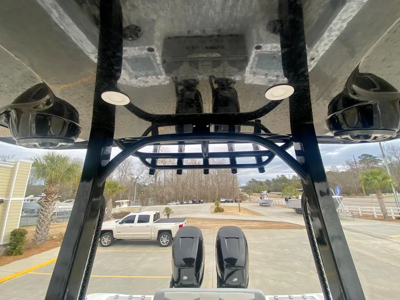 Slide: The Image of 2022 Sea Pro 320 DXL boat with dual outboard motors and T-top view. - 27