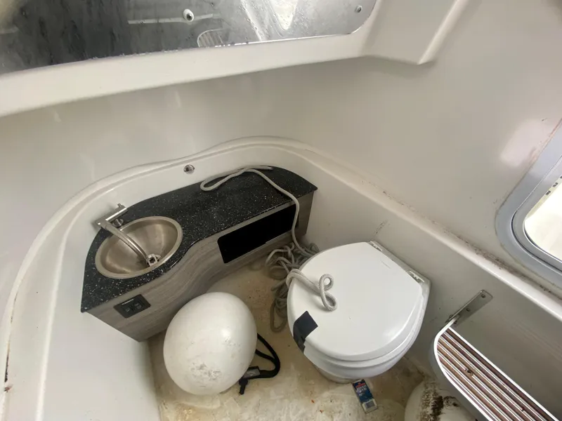 Slide: The Image of Sea Pro 320 DXL 2022 boat interior with sink and toilet. - 33