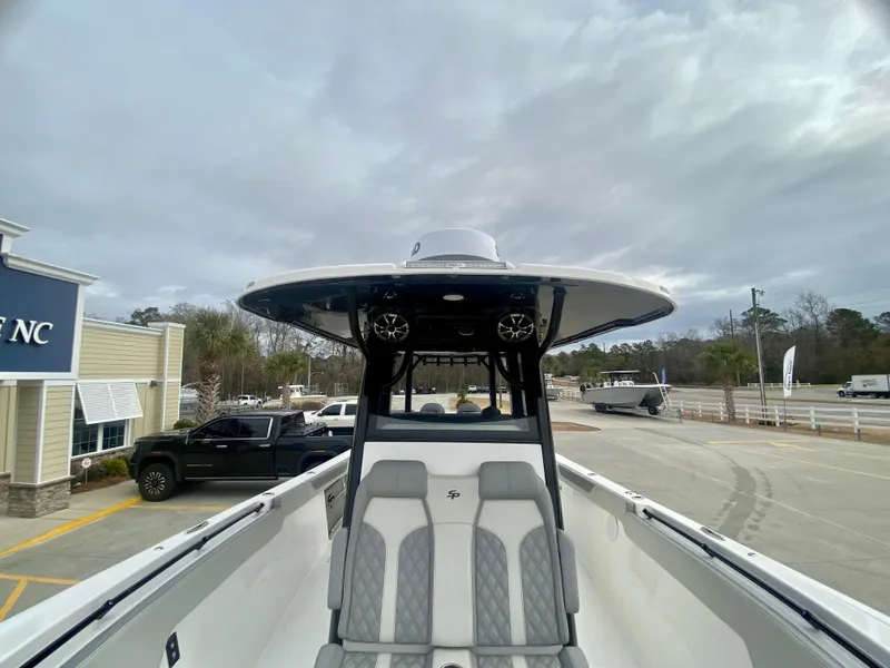 Slide: The Image of 2022 Sea Pro 320 DXL boat with seating and T-top in a parking lot. - 41