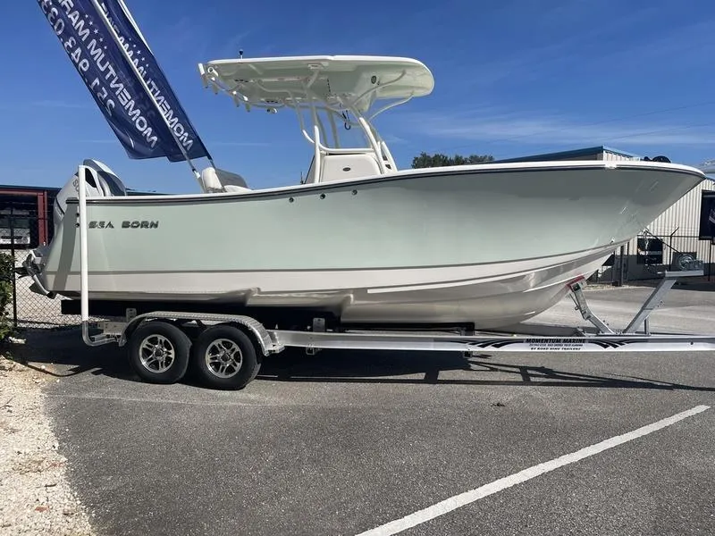 The Image of 2024 Sea Born SX239 Offshore boat on a trailer in a parking lot. - 1