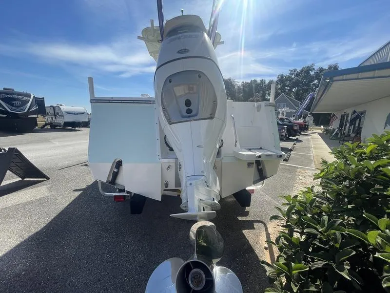 Slide: The Image of 2024 Sea Born SX239 Offshore boat rear view in a parking lot. - 10