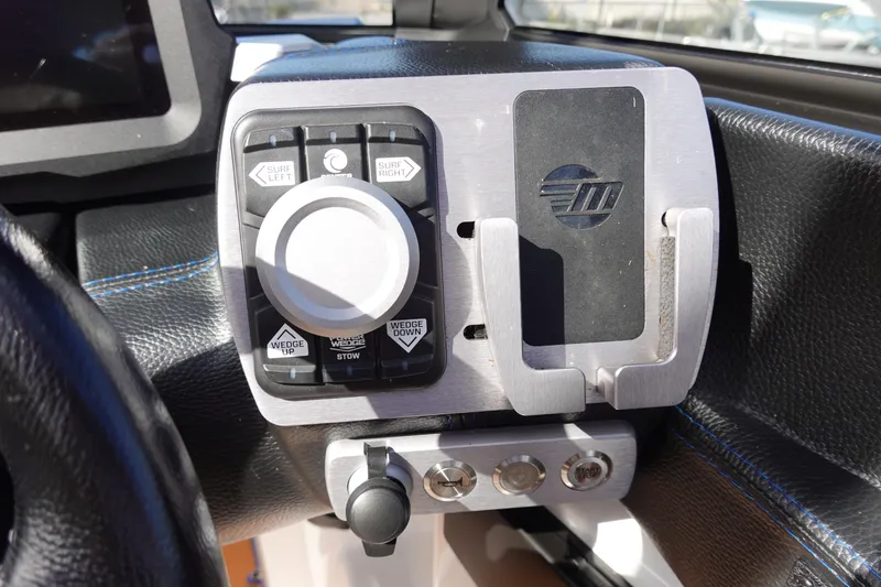 Slide: The Image of Control panel of 2023 Malibu Wakesetter 24 MXZ boat with various buttons and switches. - 12