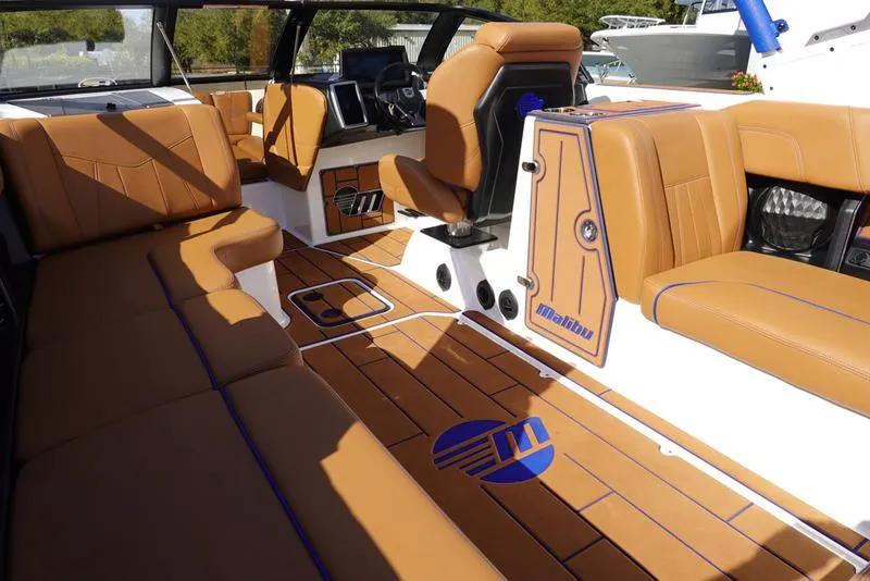 Slide: The Image of 2023 Malibu Wakesetter 24 MXZ interior with tan leather seats and custom flooring. - 22