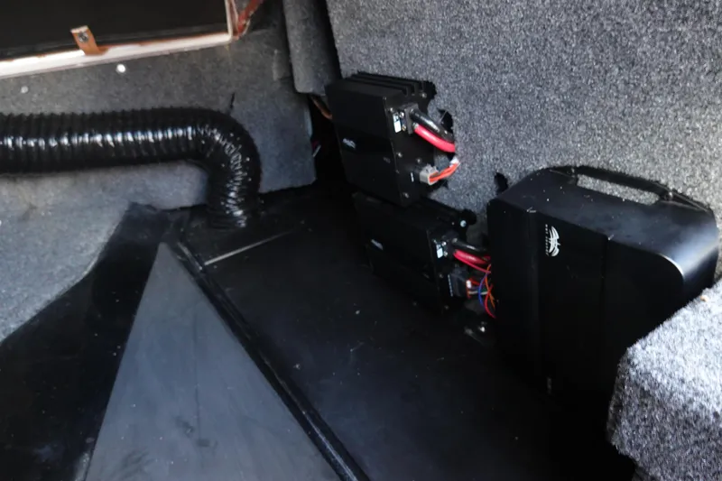 Slide: The Image of Interior of 2023 Malibu Wakesetter 24 MXZ showing electrical components and wiring. - 31