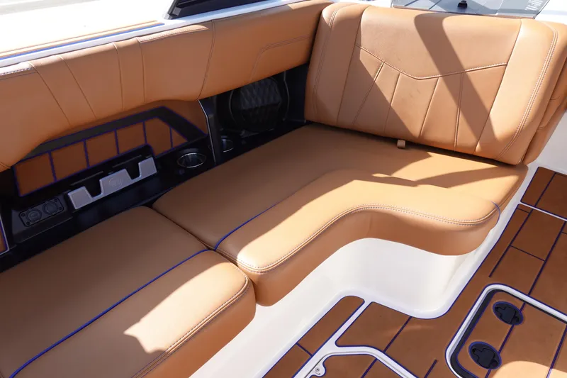 Slide: The Image of 2023 Malibu Wakesetter 24 MXZ interior seating with tan upholstery and modern design. - 32