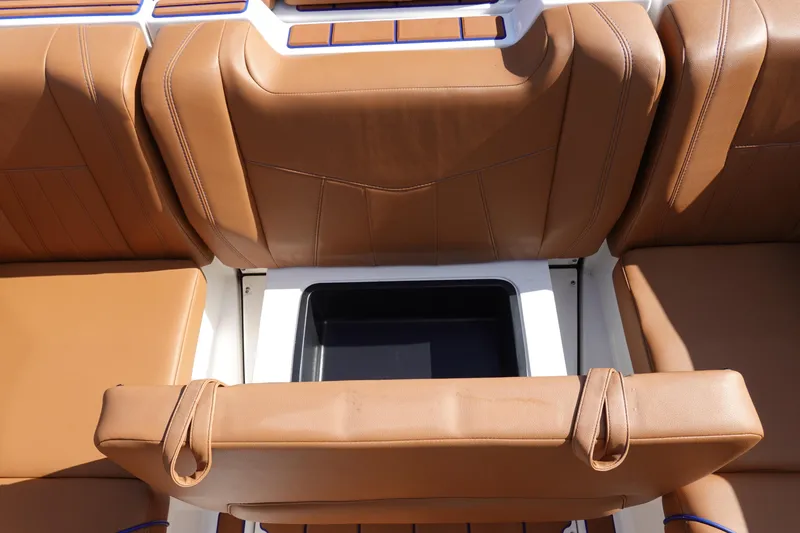 Slide: The Image of 2023 Malibu Wakesetter 24 MXZ boat with tan leather seats and storage compartment. - 36