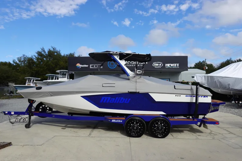Slide: The Image of 2023 Malibu Wakesetter 24 MXZ boat on trailer, covered, parked outdoors. - 45