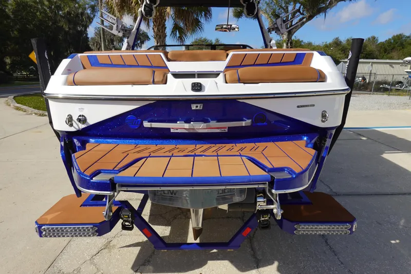 Slide: The Image of 2023 Malibu Wakesetter 24 MXZ rear view, showcasing swim platform and seating. - 6