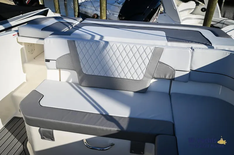 Slide: The Image of 2024 Bayliner VR5 boat interior with cushioned seating and modern design. - 13