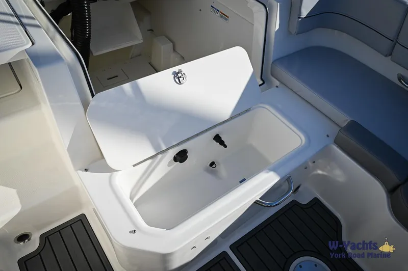 Slide: The Image of 2024 Bayliner VR5 boat interior storage compartment with open lid. - 16