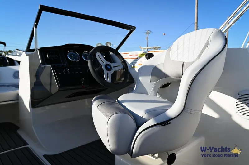 Slide: The Image of 2024 Bayliner VR5 boat cockpit with modern steering wheel and comfortable captain's chair. - 18