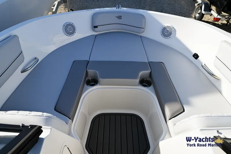 Slide: The Image of 2024 Bayliner VR5 boat interior with cushioned seating and cup holders. - 2