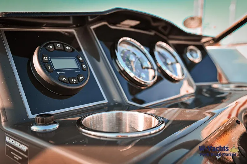 Slide: The Image of 2024 Bayliner VR5 boat dashboard with gauges and controls. - 20