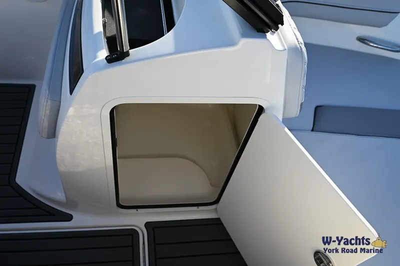 Slide: The Image of 2024 Bayliner VR5 boat storage compartment with open door. - 21
