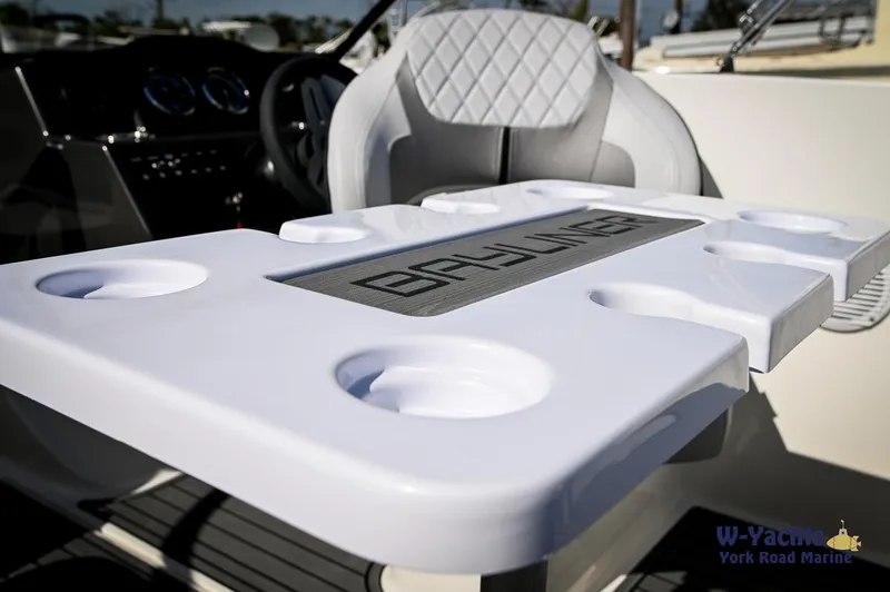 Slide: The Image of 2024 Bayliner VR5 boat interior with cup holders and seating. - 24