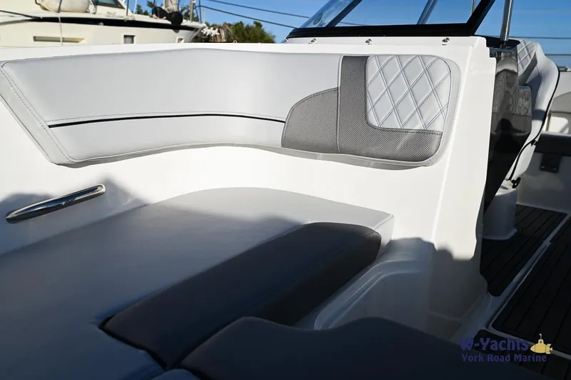 Slide: The Image of 2024 Bayliner VR5 boat interior with cushioned seating and modern design. - 5