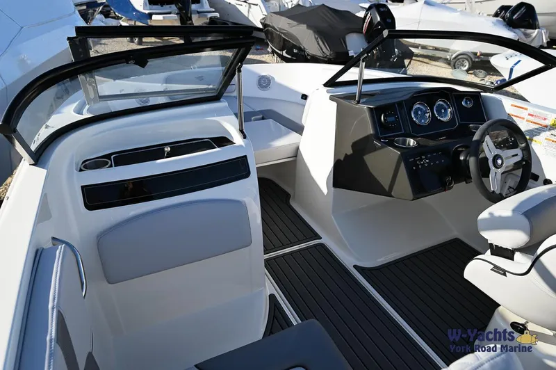 Slide: The Image of 2024 Bayliner VR5 boat interior with modern dashboard and seating. - 7