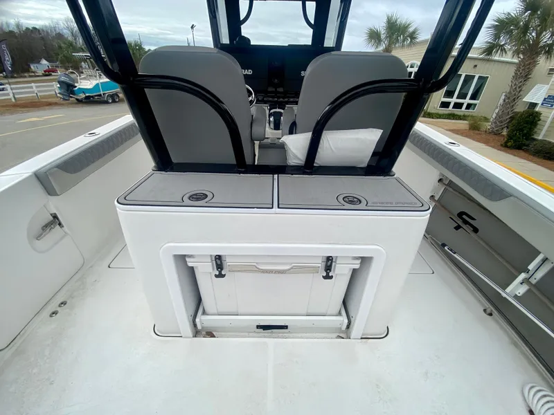 Slide: The Image of 2022 Sea Pro 320 DXL boat interior with seating and storage compartments. - 11