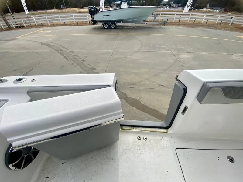 Slide: The Image of 2022 Sea Pro 320 DXL boat interior with exterior view of another boat on trailer. - 15