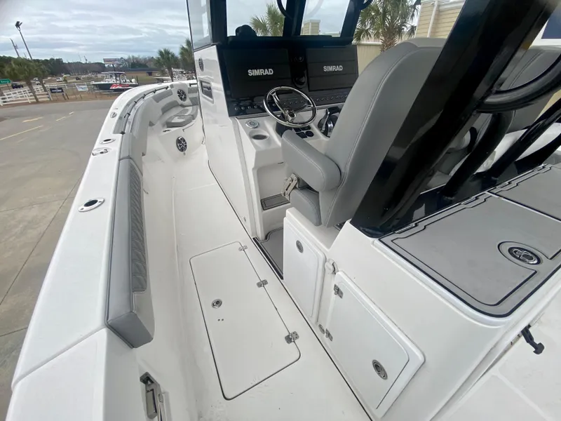 Slide: The Image of 2022 Sea Pro 320 DXL boat interior with Simrad navigation system and seating. - 16