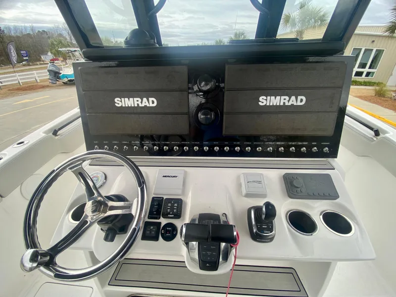 Slide: The Image of 2022 Sea Pro 320 DXL boat dashboard with Simrad electronics and steering wheel. - 21