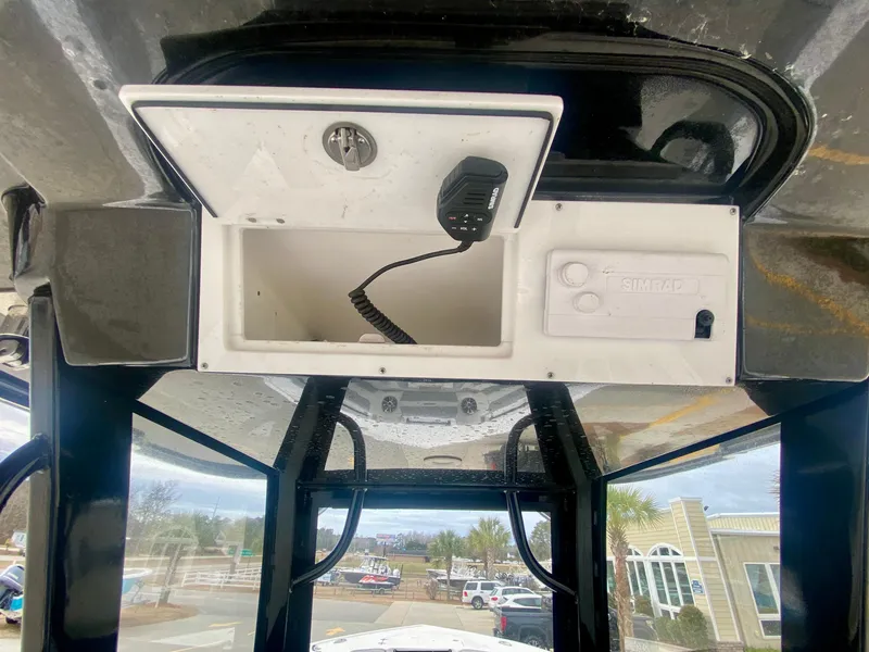 Slide: The Image of Storage compartment and radio on a 2022 Sea Pro 320 DXL boat. - 26