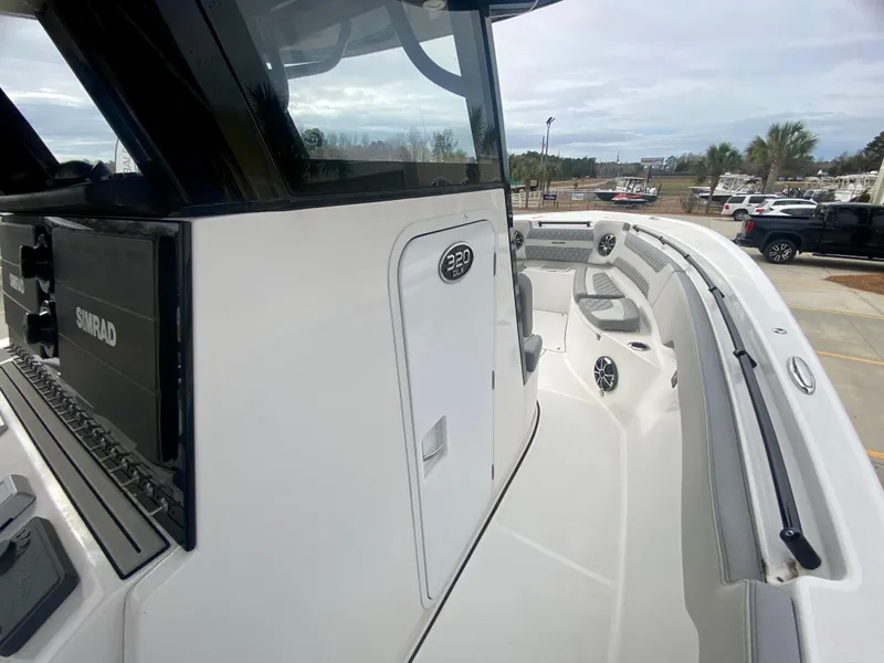 Slide: The Image of 2022 Sea Pro 320 DXL boat deck with Simrad electronics and spacious seating. - 28