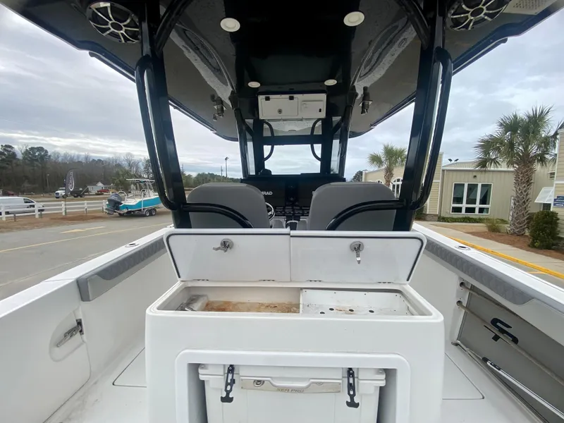 Slide: The Image of 2022 Sea Pro 320 DXL boat interior with helm and storage compartments. - 14