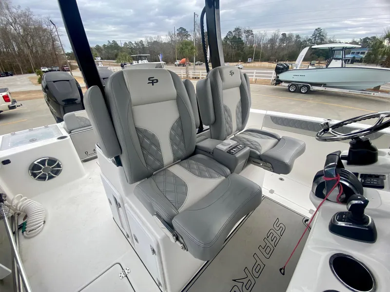 Slide: The Image of 2022 Sea Pro 320 DXL boat interior with dual captain's chairs and control console. - 20