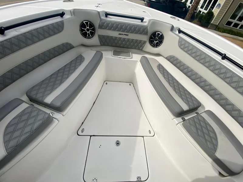 Slide: The Image of 2022 Sea Pro 320 DXL boat interior with cushioned seating and speakers. - 35