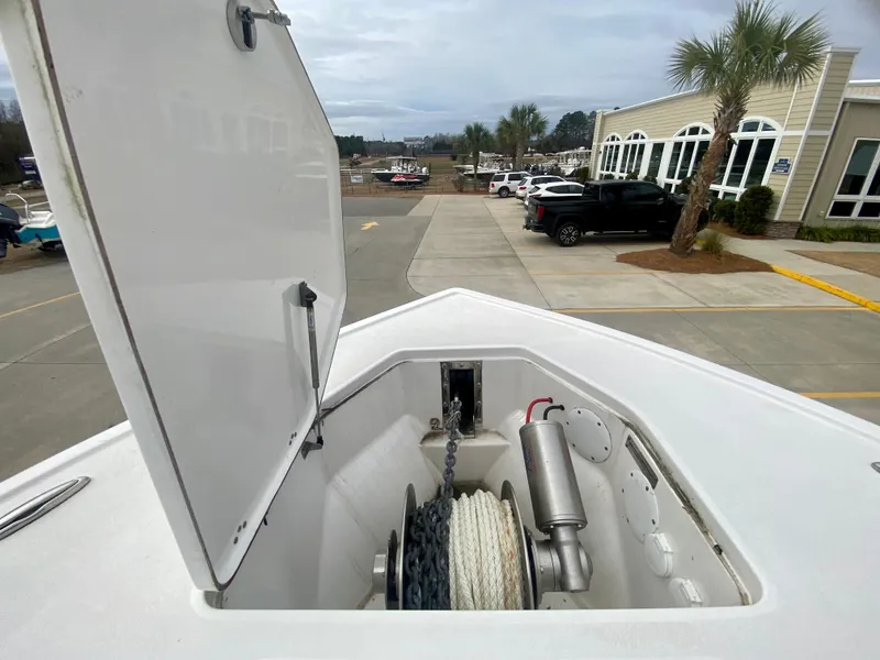 Slide: The Image of Anchor storage compartment on a 2022 Sea Pro 320 DXL boat, open lid view. - 40