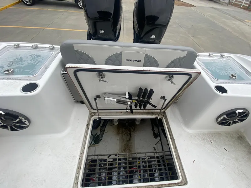 Slide: The Image of 2022 Sea Pro 320 DXL boat with open hatch and twin outboard motors. - 9