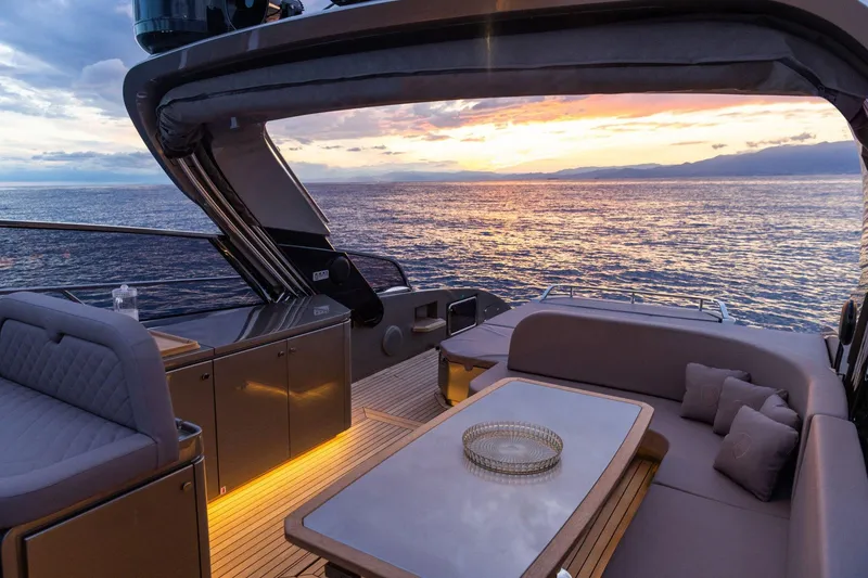 Slide: The Image of Luxury 2024 Rizzardi GR SESSANTATRE yacht interior at sunset, featuring elegant seating and ocean view. - 11