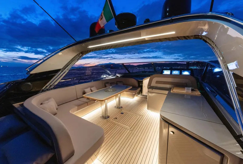 Slide: The Image of Luxurious 2024 Rizzardi GR SESSANTATRE yacht interior with elegant seating and ambient lighting at sunset. - 13