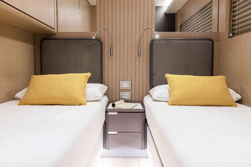 Slide: The Image of Twin beds in the 2024 Rizzardi GR SESSANTATRE yacht cabin with yellow pillows. - 16
