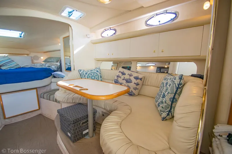 Slide: The Image of 1999 Sea Ray 340 Sundancer interior with cozy seating and nautical decor. - 10
