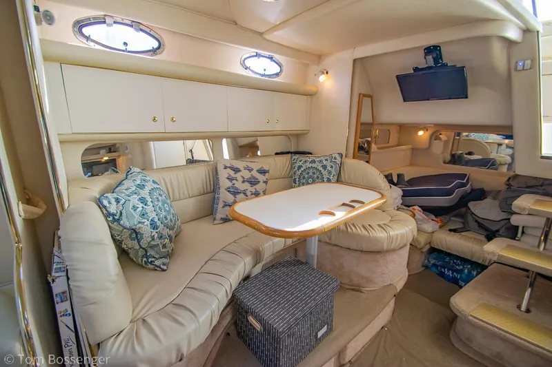 Slide: The Image of Interior of 1999 Sea Ray 340 Sundancer yacht with cozy seating and modern amenities. - 14