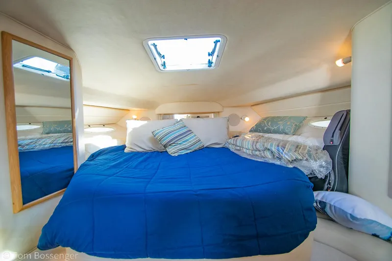 Slide: The Image of Interior cabin of 1999 Sea Ray 340 Sundancer with blue bedding and skylight. - 15