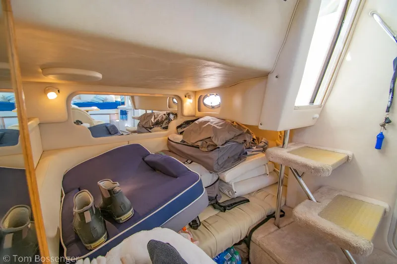 Slide: The Image of Interior cabin of 1999 Sea Ray 340 Sundancer with cozy sleeping area and storage. - 18