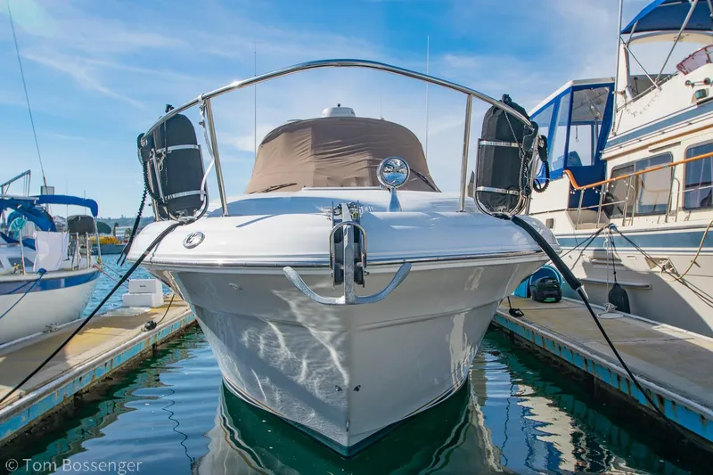 Slide: The Image of 1999 Sea Ray 340 Sundancer yacht docked at marina under clear blue sky. - 3