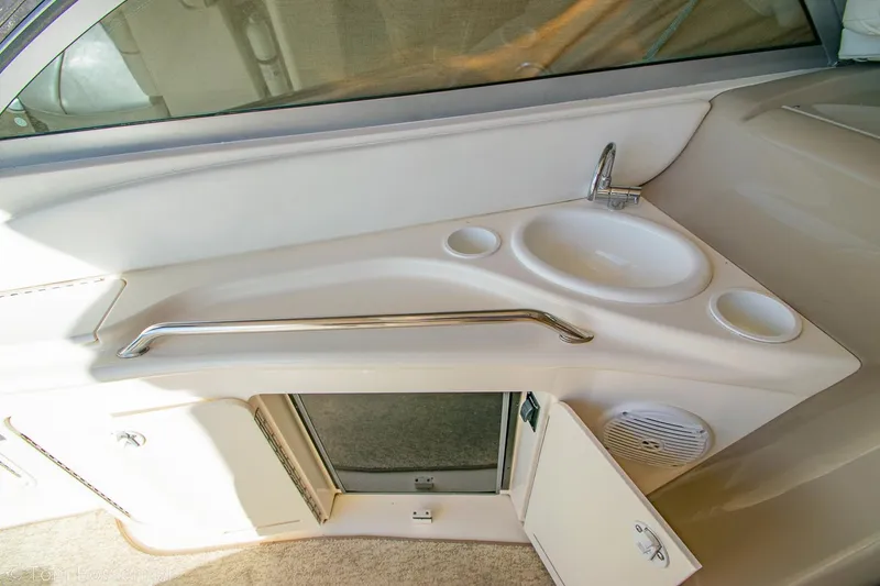 Slide: The Image of 1999 Sea Ray 340 Sundancer interior with sink and storage compartment. - 33