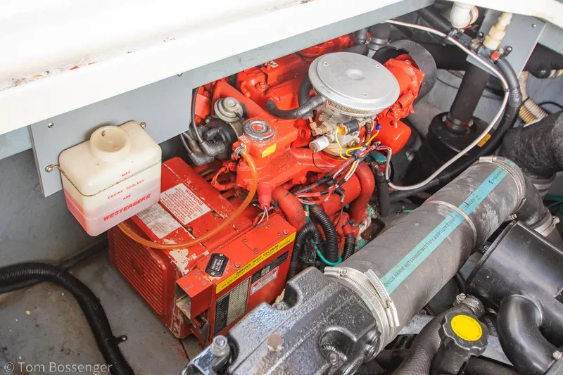 Slide: The Image of Engine compartment of a 1999 Sea Ray 340 Sundancer boat, featuring a red engine. - 37