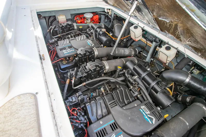Slide: The Image of Engine compartment of a 1999 Sea Ray 340 Sundancer boat, showcasing dual engines and components. - 38