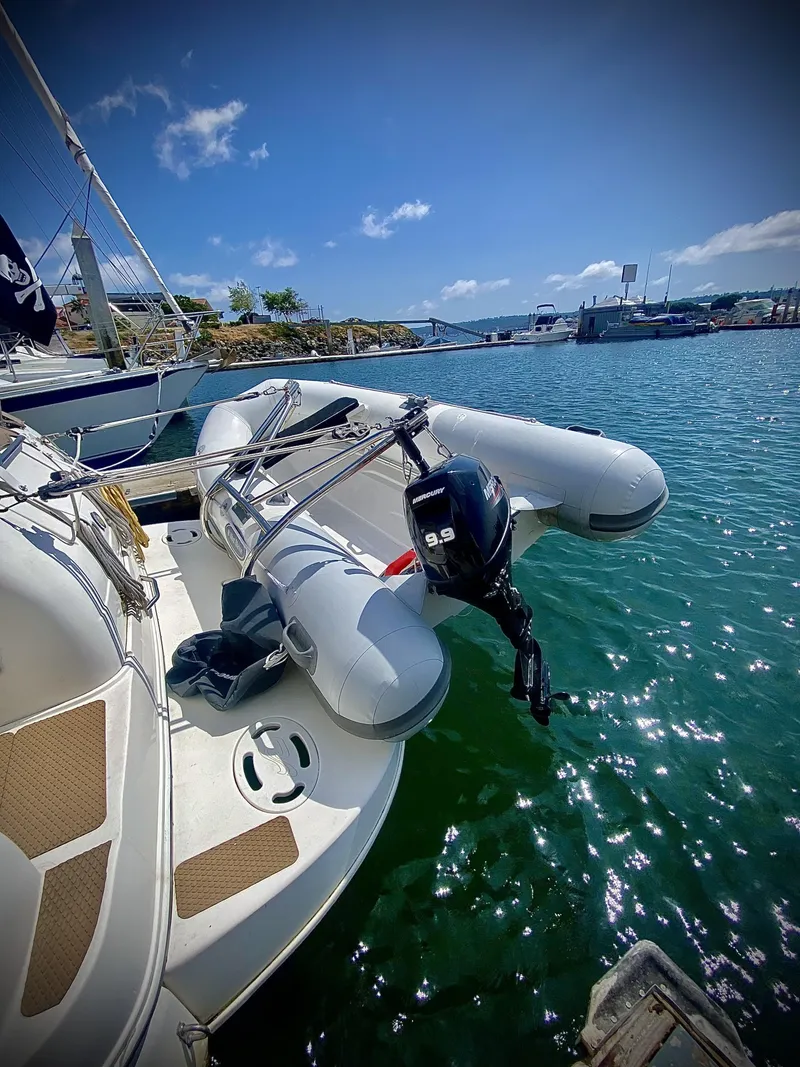 Slide: The Image of 1999 Sea Ray 340 Sundancer with inflatable dinghy on calm water. - 39