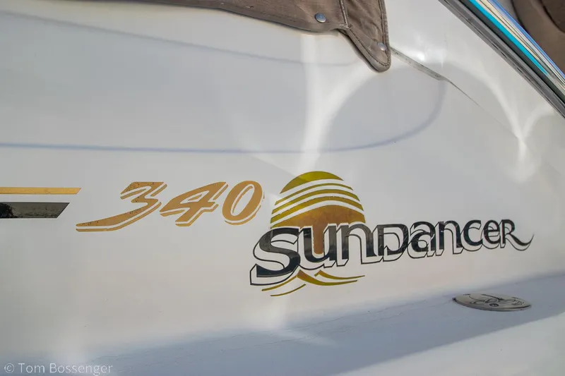 Slide: The Image of 1999 Sea Ray 340 Sundancer boat logo on white hull. - 5